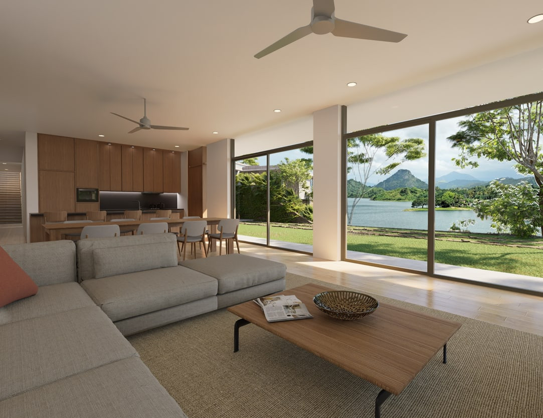 An open-plan living and dining room with floor-to-ceiling glazing onto the lake